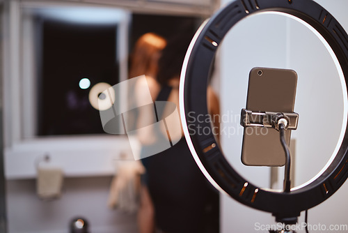 Image of ring light, phone and woman influencer equipment with friends live streaming getting ready. Night, creative gen z content and internet production tech with blurred background and mockup in a home