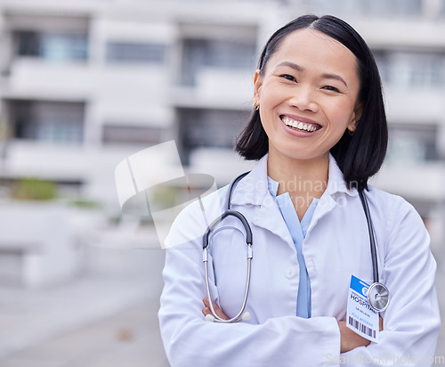 Image of Leadership, happy and portrait of a doctor by hospital with success after surgery or consultation. Happiness, smile and Asian female healthcare worker with confidence standing outdoor medical clinic.