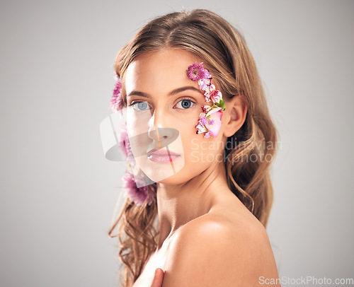 Image of Beauty, flower and portrait of woman in studio for natural cosmetics, skincare wellness and makeup products. Spring, art and girl with petal on face for spa aesthetic, luxury facial and cosmetology