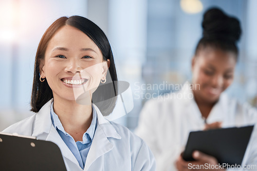 Image of Asian doctor woman, checklist and portrait with smile, planning or happy at clinic with african expert. Medic, teamwork and clipboard for schedule, analysis or results in hospital for healthcare goal