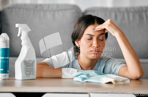 Image of Headache, cleaning stress and tired black woman cleaner feeling burnout from housekeeping. Home, dust cloth and fatigue of house worker with hygiene products for furniture in a living room lounge