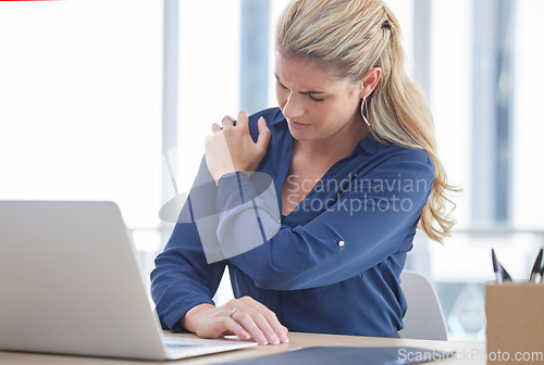 Image of Business woman, laptop and shoulder pain suffering from work injury, accident or ache at the office desk. Female employee holding painful area in discomfort, sore or bruised bone at the workplace