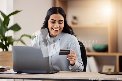 Image of Credit card, laptop and happy woman for online shopping, e commerce and payment on fintech in her office. Employee, indian person or worker on computer for internet banking, online investment or sale