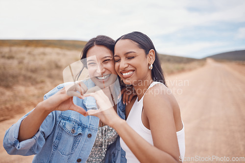 Image of Friendship, heart shape and women in nature on a holiday, adventure or weekend trip together. Happy, smile and female best friends with love hand gesture, sign or emoji on vacation in the countryside