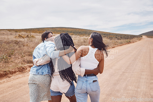 Image of Woman, friends and walking in hug for countryside travel, adventure or vacation trip together outdoors. Happy women hugging and taking a walk enjoying social life and traveling in dessert safari