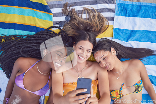 Image of Beach selfie, girl friends and happiness by the sea lying on a towel feeling freedom with a smile. Summer, students and girls in Miami taking profile picture for social media in summer at ocean