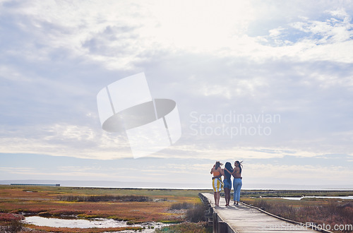 Image of Travel, friends and women walking while on a vacation, adventure or outdoor journey in nature. Freedom, bonding and female best friends on a walk while on a holiday or weekend trip in the countryside