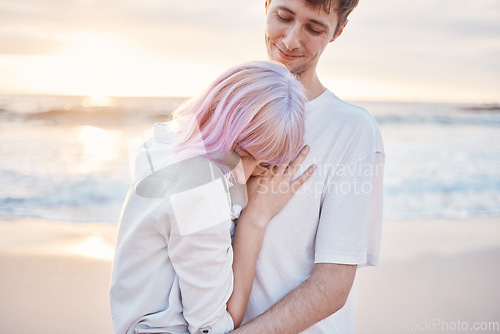 Image of Love, beach and young couple on date for valentines day, ocean fun and romantic embrace at sunset. Romance, happiness and gen z woman and man hug on tropical valentine holiday in Indonesia in evening