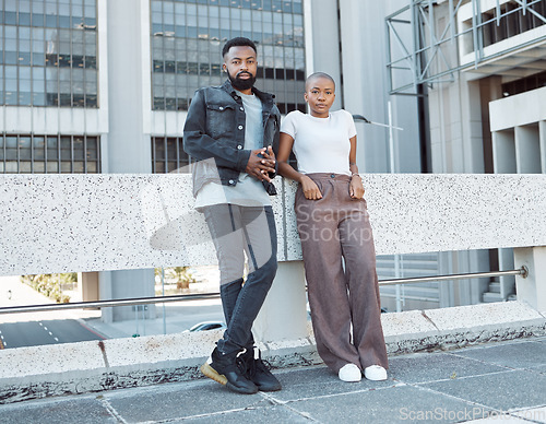Image of Date, urban and portrait of an African couple in the city for fashion, weekend fun and vacation. Fashionable, serious and black man and woman standing on a bridge for bonding and time in South Africa