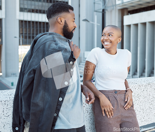 Image of Talking, black people and couple of friends in a city with happiness and conversation outdoor. Urban lifestyle, happy woman and communication by a building with partner and smile from discussion