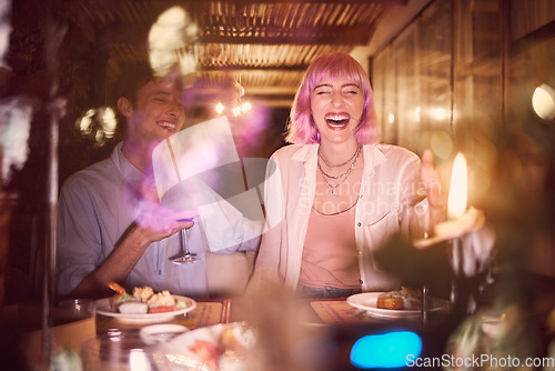 Image of Happy couple at dinner, celebration at restaurant with fine dining, love and anniversary with young people laughing. Funny, happiness and eating, care in relationship with commitment and partnership