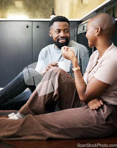 Image of Conversation, happy and African couple with coffee for peace, love and care on the kitchen floor. Communication, smile and black man and woman drinking tea while talking about their relationship