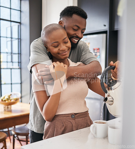 Image of Morning, hug and African couple making coffee for energy, drink and routine in the kitchen. Smile, affection and black man and woman hugging while preparing tea, bonding and relaxing in their home