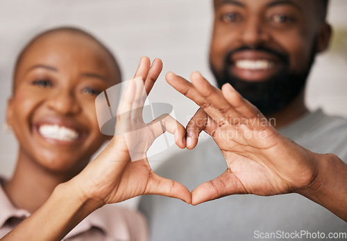 Image of Love, hands in heart and black couple with smile for relationship, dating and commitment in home. Happy, emoji and face of black woman and man smile with hand shape for bonding, romance and trust