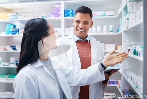 Image of Pharmacy, employees and discussion with healthcare, inventory for stock and teamwork. Pharmacist, man and woman talking, planning and prescriptions with happiness, staff and medical professionals