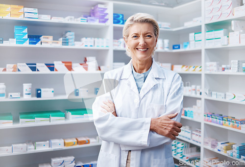 Image of Portrait, senior woman and pharmacist with arms crossed in pharmacy, drugstore or shop. Healthcare, wellness and happy, proud and confident elderly female medical professional or doctor from Canada.