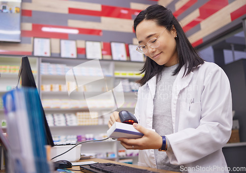 Image of Pharmacy, smile and asian woman scanning medicine at checkout counter for prescription drugs. Healthcare, pills and pharmacist from Japan with medical product in box and digital scanner in drugstore.