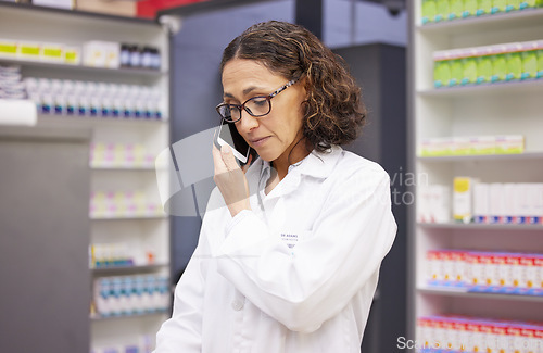Image of Phone call, pharmacy and medicine with a woman taking an order in a drugstore for prescription or treatment. Mobile, contact and healthcare with a female pharmacist talking in a hospital dispensary