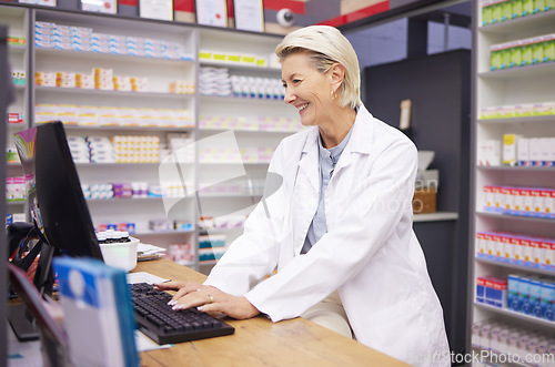 Image of Pharmacy, computer database and senior woman pharmacist working of medicine research. Pharmaceutical data, typing and healthcare employee smile checking online information for medical prescription