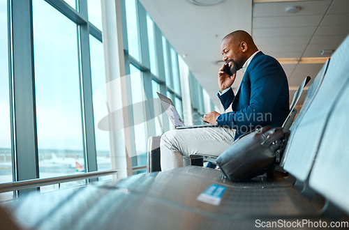 Image of Phone call, travel and businessman on a laptop in the airport for work company trip in the city. Technology, communication and African male employee on mobile conversation waiting to board his flight