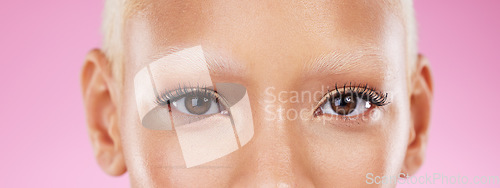 Image of Beauty, portrait and eyes with mascara in a studio with a natural cosmetic or makeup routine. Eyelashes, self care and closeup of beautiful female model with eye cosmetics isolated by pink background