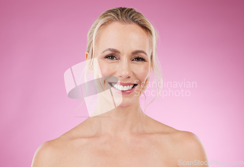 Image of Beauty, skincare and portrait of woman with smile, glowing skin and and natural spa makeup in studio. Mockup, advertising and luxury cosmetics, face of happy blonde model isolated on pink background.
