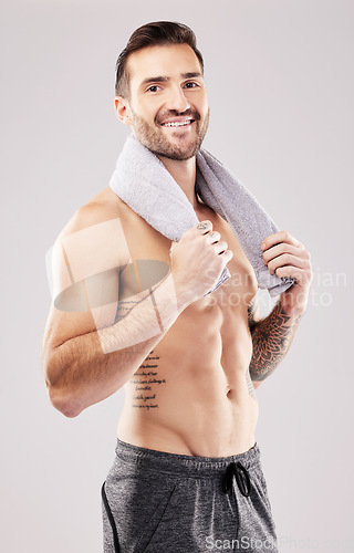 Image of Body, man in portrait and fitness with beauty, grooming and hygiene with health and clean on studio background. Happy, topless male with towel and cosmetics with bodybuilder, exercise and muscle
