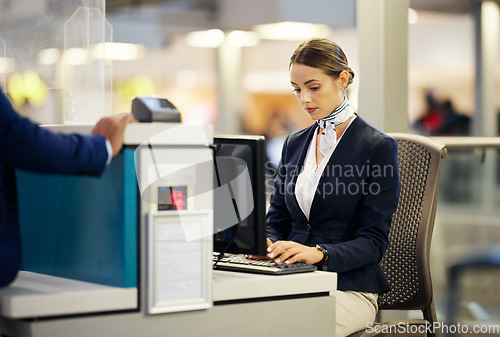 Image of Airport, check in desk and woman typing for security, identity and travel documents for border immigration service. Concierge, customer service and help for global transportation with pc on table