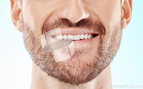 Image of Teeth, smile and mouth of a man for dental care isolated on a blue background in a studio. Beard, happy and model showing results from whitening of tooth and promotion of an oral hygiene treatment