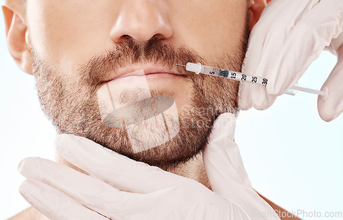 Image of Man, lip filler injection and mesotherapy with face, hands and needle syringe and beauty on blue background. Dermatology, cosmetic care and procedure, health and skincare with wellness and collagen
