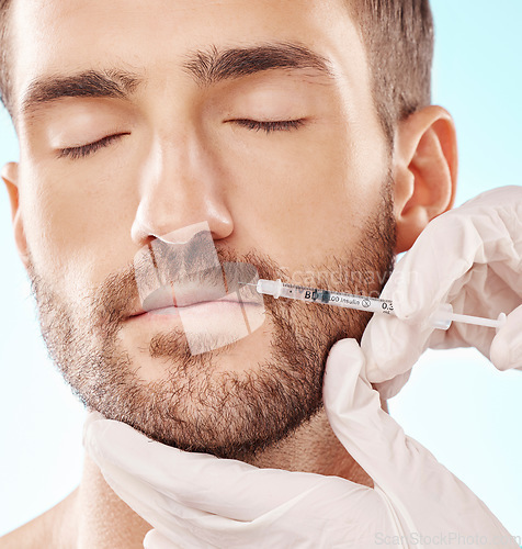 Image of Man, lip filler and mesotherapy with face, hands and needle syringe, injection and beauty on blue background. Dermatology, cosmetic care and procedure, health and skincare with wellness and collagen