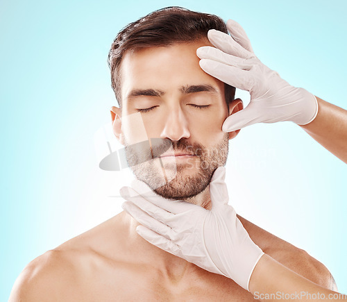 Image of Man, face and facial care, hands and cosmetic service with beauty, healthy skin and glow on blue background. Dermatology, cosmetics and procedure, health and skincare with wellness and collagen