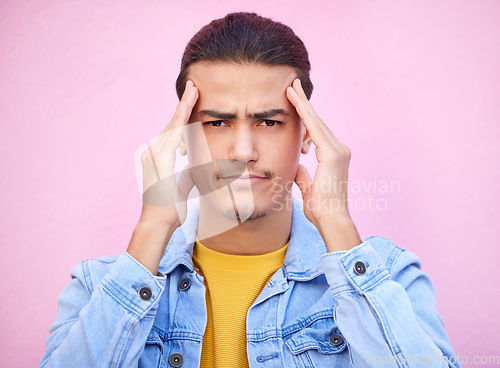 Image of Portrait, stress and man with headache in studio isolated on a pink background. Mental health, anxiety and face of depressed and sad male model with depression, pain or migraine, burnout or head ache