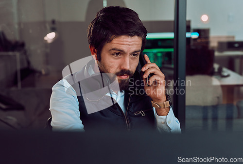 Image of Programmer, phone call and man talking, thinking or chatting and speaking to contact at night office. Information technology, idea and male coder with mobile for networking while looking at computer.