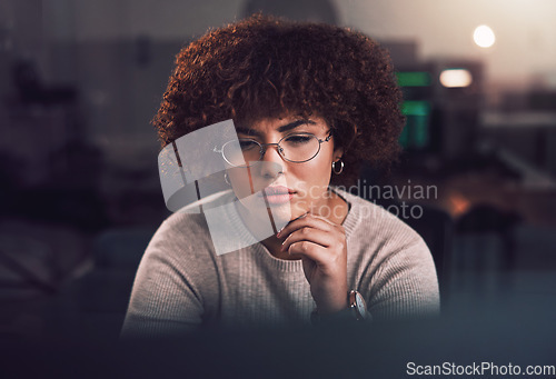 Image of Night, computer and black woman programmer, software development and cybersecurity analysis. Focus, thinking and person working, network monitor and information technology programming at USA company