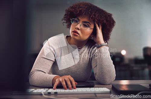 Image of Thinking, confused and night with a black woman programmer working late in her office for cybersecurity. Idea, doubt and overtime with a female developer at work for research or data analysis