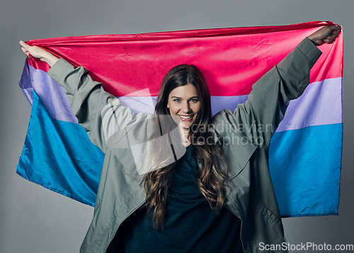 Image of Bisexual flag, pride and happy woman, lgbtq and freedom to love, inclusion and equality, protest for human rights. Gay, trans and identity, politics and community in portrait on studio background