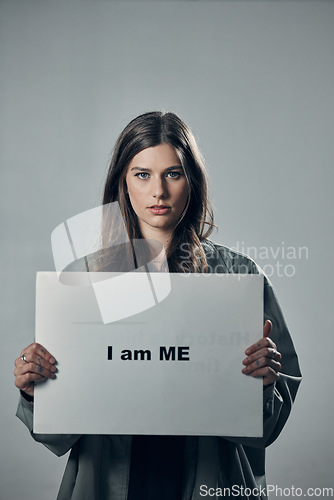 Image of Woman, protest and poster in pride for self esteem, equality or human rights against gray studio background. Portrait of confident female activist with I am me message on board for unique empowerment