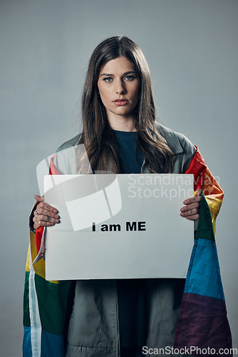 Image of Woman, protest and poster in pride for gay, LGBTQ equality or human rights against gray studio background. Portrait of confident female activist with I am me message board for sexuality empowerment