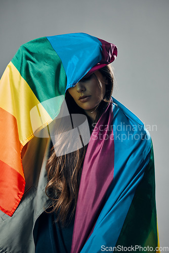 Image of Rainbow flag, pride and woman, lgbtq and freedom to love, inclusion and equality, protest for human rights. Gay, trans and lesbian, politics and identity with community isolated on studio background