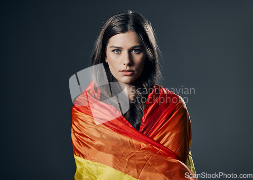 Image of Flag, pride and woman in portrait, lgbtq and freedom to love, inclusion and equality, protest for human rights. Gay, trans and lesbian, politics and identity with lgbt community on studio background