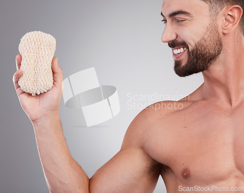 Image of Hygiene, man and sponge for cleaning, smile and wellness with guy on grey studio background. Male, gentleman and skincare for washing, happiness and grooming routine for health, smooth and soft skin