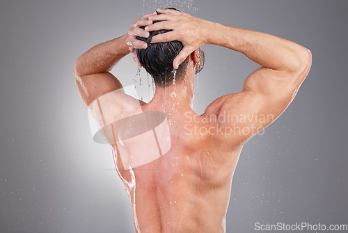 Image of Shower, cleaning and back of man with water in studio background for wellness, grooming and beauty. Skincare, bathroom hygiene and male smile for washing hair, clean body and soap for healthy skin