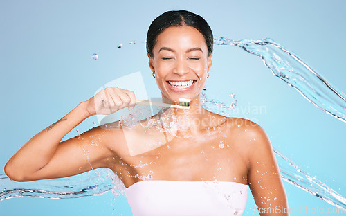 Image of Bamboo toothbrush of black woman isolated on blue background with toothpaste, water splash and dental health. Model or person brushing teeth with eco friendly and sustainable product in studio mockup