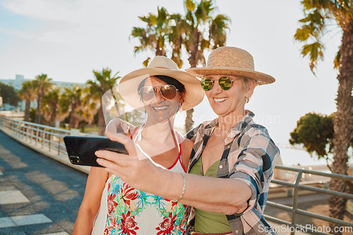 Image of Happy friends, selfie and holiday smile in Miami with happiness from summer travel and vacation. Beach, mobile connection and online mature women by the sea with happiness on 5g for social media