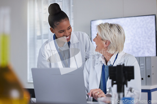 Image of Teamwork, laptop and collaboration of doctors in laboratory for medical research or science. Computer, comic and researchers, black woman and senior female, talking and laughing at funny comedy meme.