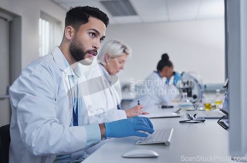 Image of Typing, focus scientist working on computer in lab for medical search, innovation or science study in hospital. Medicine, internet or group of doctors on tech for healthcare or wellness DNA research