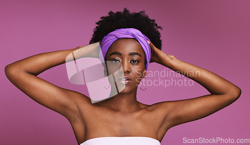 Image of Portrait, beauty and hair with a model black woman on a pink background in studio for natural care. Face, skincare or headband and an attractive or confident young female wearing an afro hairstyle