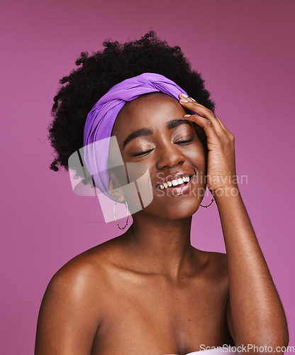 Image of Face, beauty and skincare with a model black woman on a pink background in studio for natural care. Facial, hair and headband with an attractive young female posing to promote cosmetic treatment