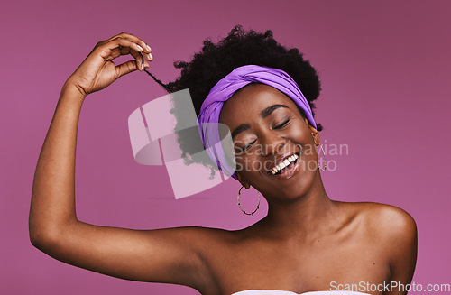 Image of Hair, beauty and afro with a model black woman on a pink background in studio for natural care. Face, haircare and headband with an attractive young female posing to promote cosmetic treatment